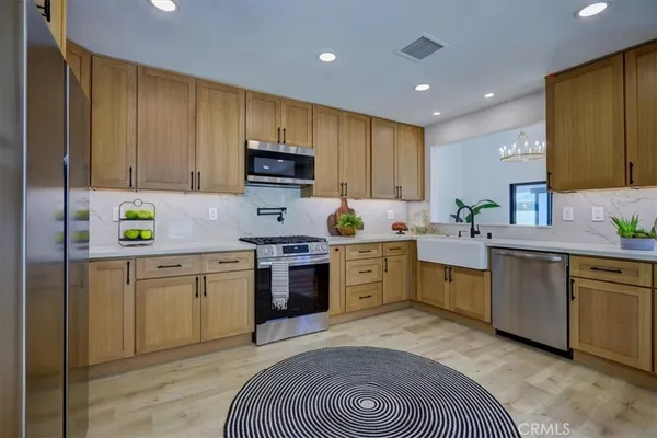 a kitchen with cabinets a sink and wooden floor
