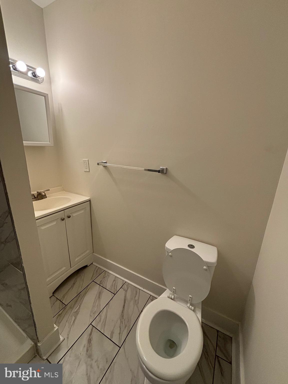 5427 Walnut Street, Unit F1 Philadelphia, PA 19139 - Photo 12 of 22 a bathroom with a toilet and a sink