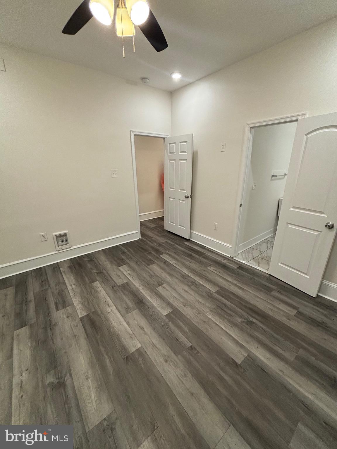 5427 Walnut Street, Unit F1 Philadelphia, PA 19139 - Photo 14 of 22 an empty room with a ceiling fan and wooden floor