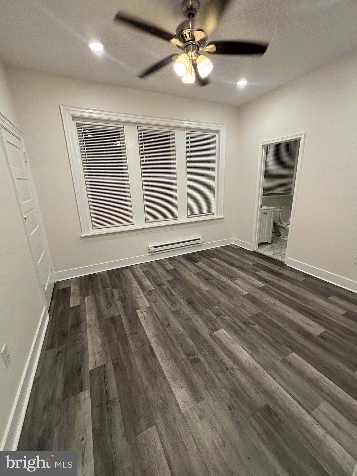 5427 Walnut Street, Unit F1 Philadelphia, PA 19139 - Photo 18 of 22 wooden floor in an empty room with a window