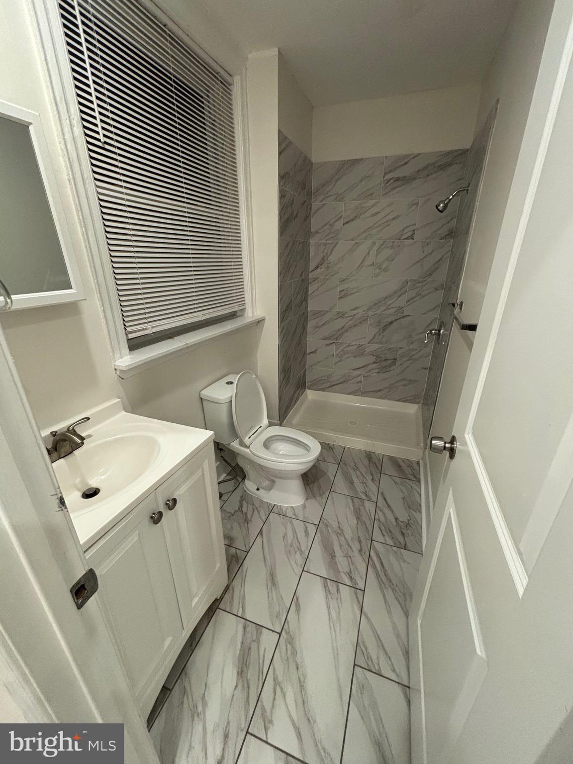 5427 Walnut Street, Unit F1 Philadelphia, PA 19139 - Photo 19 of 22 a bathroom with a sink a toilet and shower
