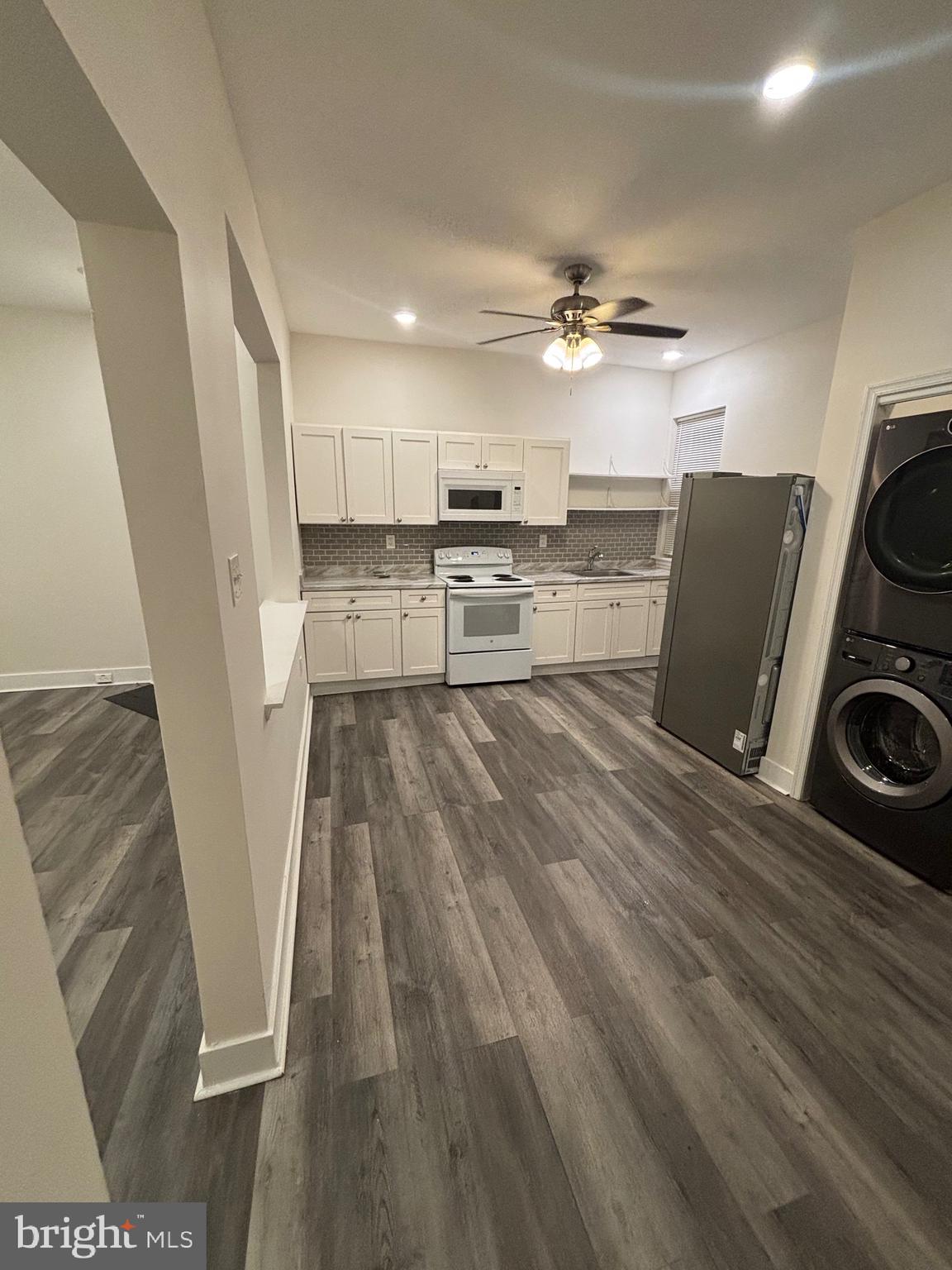 5427 Walnut Street, Unit F1 Philadelphia, PA 19139 - Photo 4 of 22 a living room with stainless steel appliances furniture and a fireplace
