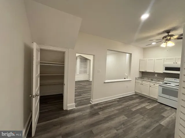 a large white kitchen with a stove a sink and dishwasher