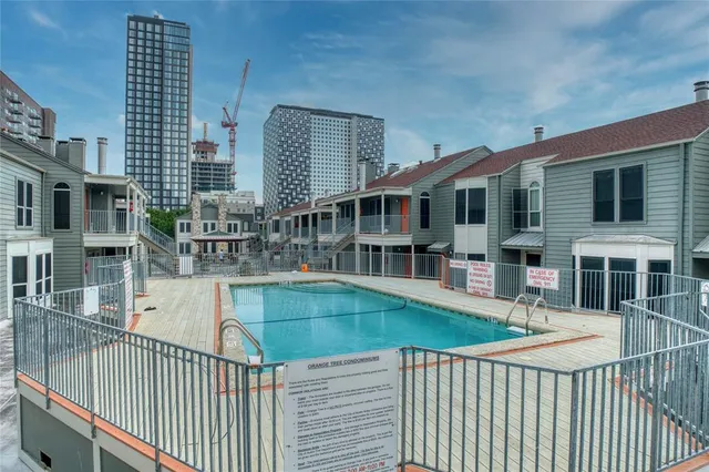 a view of a house with swimming pool and sitting area