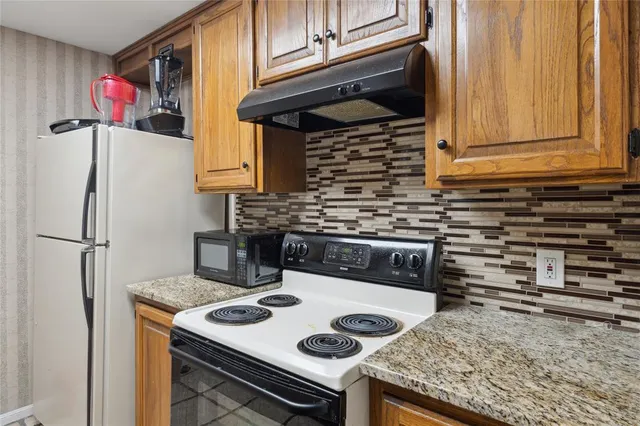 a kitchen with a stove and a refrigerator