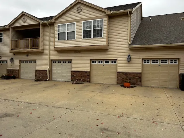 a view of a house with a parking space in front of it