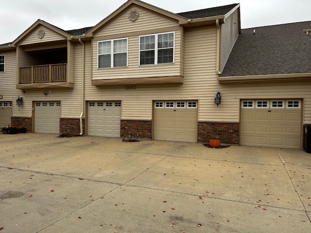 a view of a house with a parking space in front of it