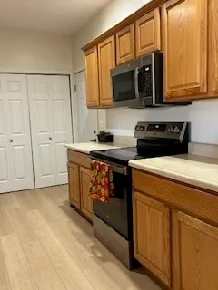 a kitchen with stainless steel appliances granite countertop a sink a stove and cabinets