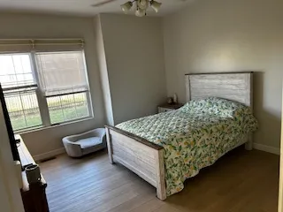 a bedroom with a bed and a window