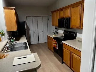 a kitchen with a sink stove and a refrigerator