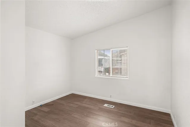 an empty room with wooden floor