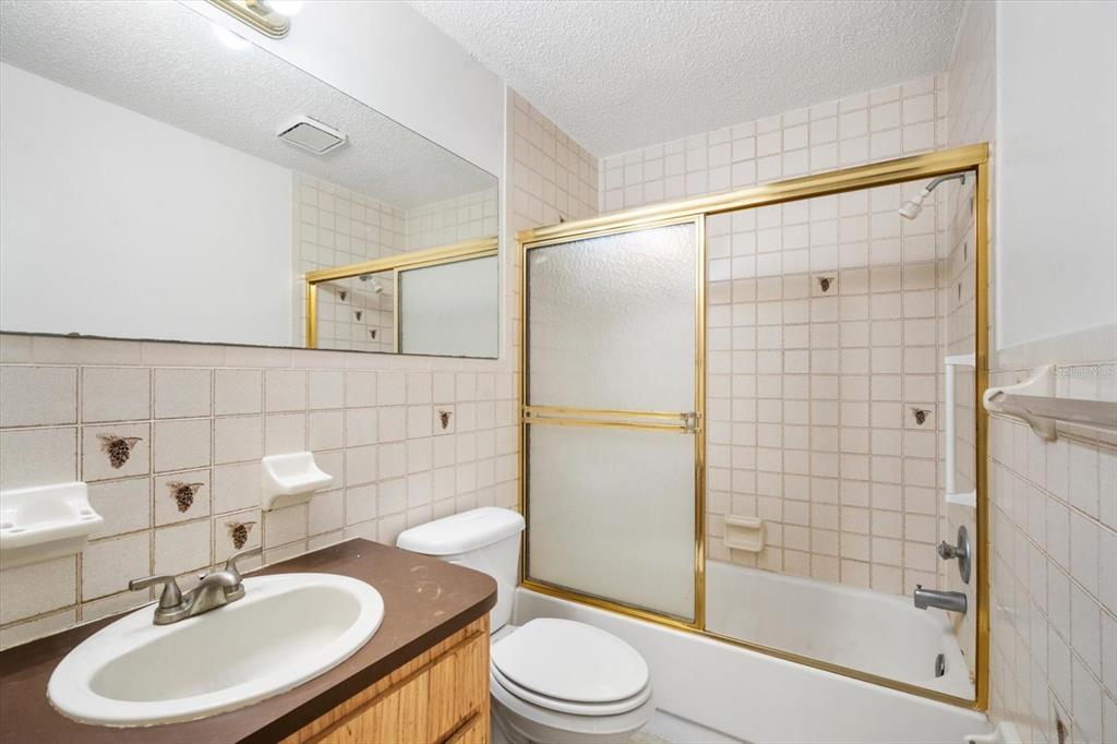 6636 Timbercove Lane New Port Richey, FL 34653 - Photo 14 of 20 a bathroom with a sink toilet and shower