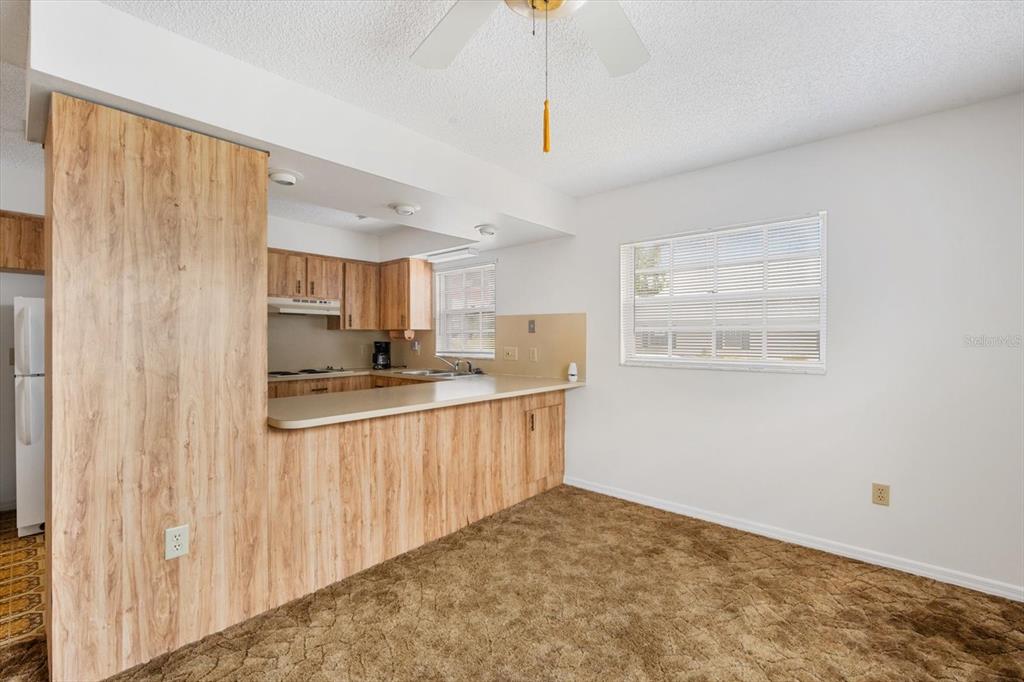6636 Timbercove Lane New Port Richey, FL 34653 - Photo 6 of 20 a kitchen with stainless steel appliances granite countertop a stove a sink and a refrigerator