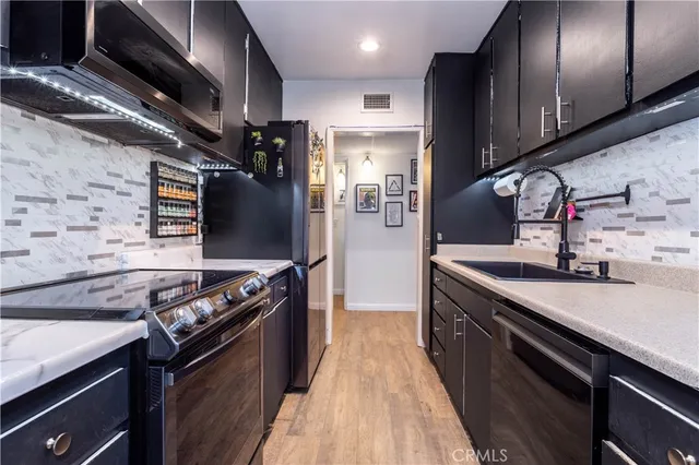 a kitchen with stainless steel appliances granite countertop a stove and a sink