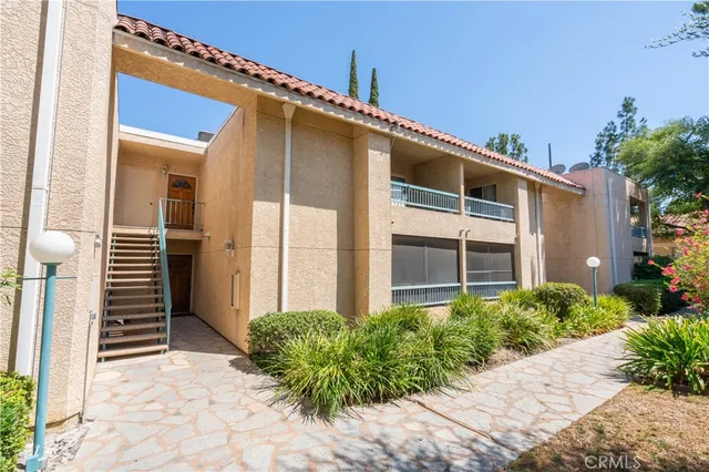 a house with a large window potted plants