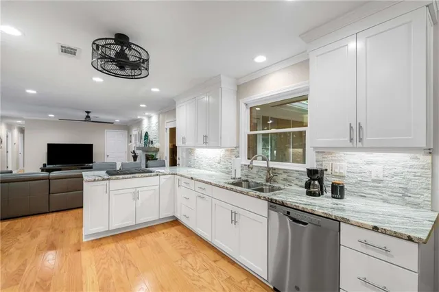 a kitchen with a sink cabinets and window