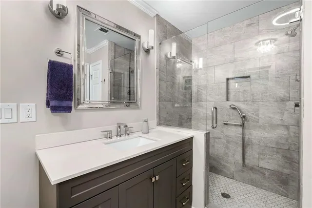 a bathroom with a sink mirror and a shower