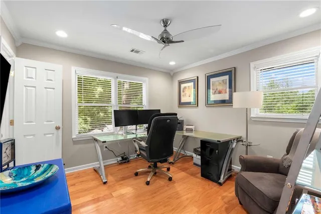 a view of a livingroom with workspace and a window