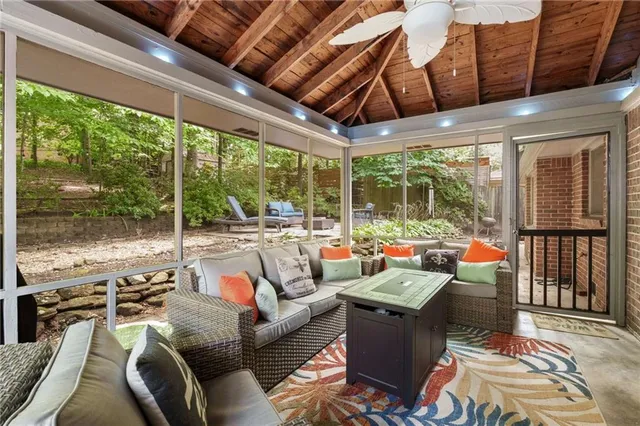a living room with furniture and a floor to ceiling window