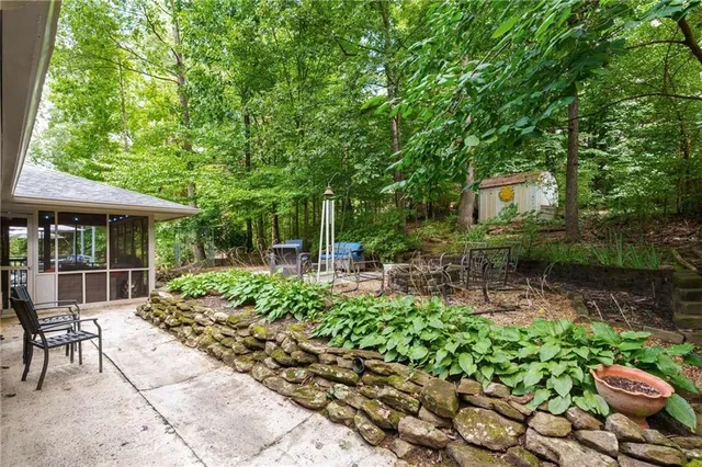 a backyard of a house with table and chairs