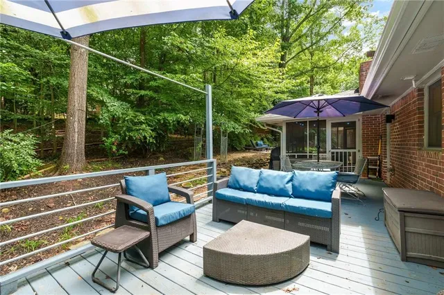 a view of patio with couches chairs and wooden floor