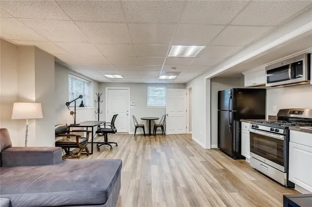 a living room with furniture and a wooden floor