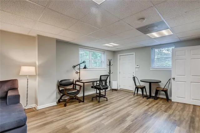 a view of a work space with furniture and wooden floor