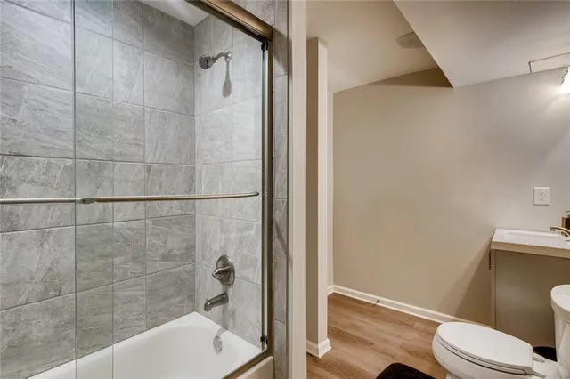 a bathroom with a toilet and a shower