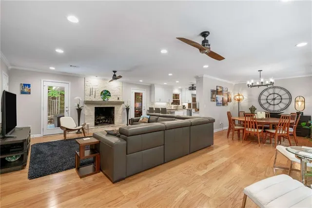 a living room with furniture a fireplace and a flat screen tv