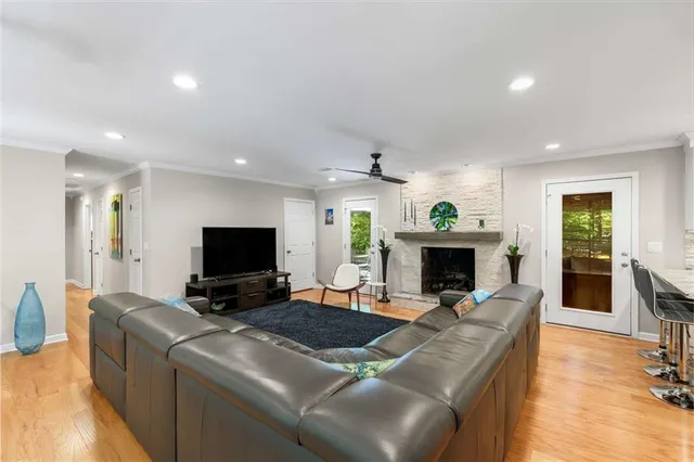a living room with furniture a fireplace and a flat screen tv