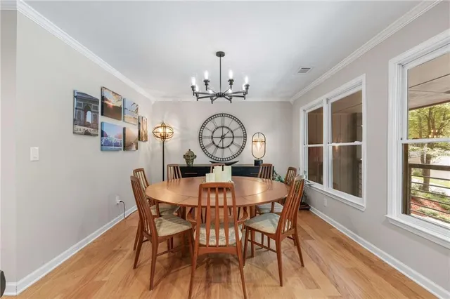 a view of a dining room with furniture window and wooden floor
