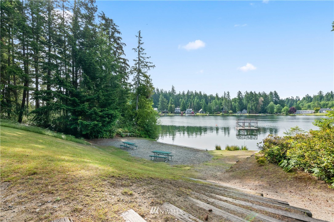 8810 Johnson Road Anderson Island, WA 98303 - Photo 7 of 11 a view of a lake with a big yard and large trees