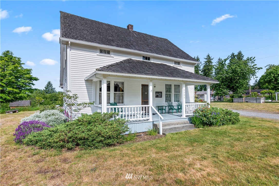 8810 Johnson Road Anderson Island, WA 98303 - Photo 10 of 11 a front view of a house with garden