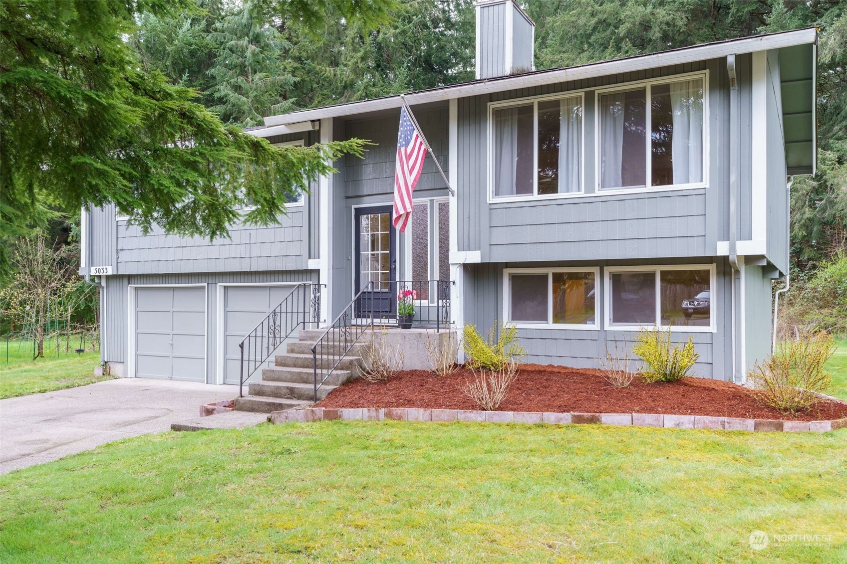 5033 Tri Lake Loop Southeast Olympia, WA 98513 - Photo 1 of 34 a front view of a house with a garden and yard