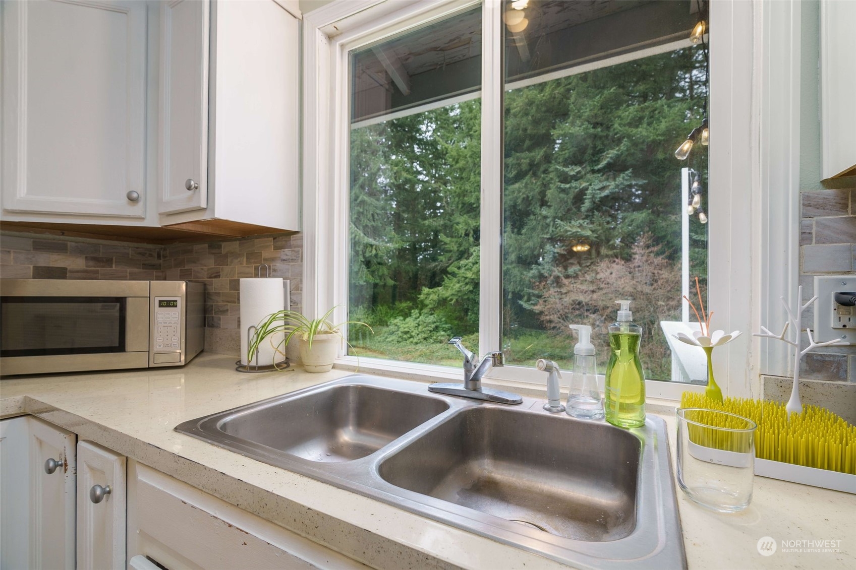 5033 Tri Lake Loop Southeast Olympia, WA 98513 - Photo 14 of 34 a kitchen with a sink and a large window