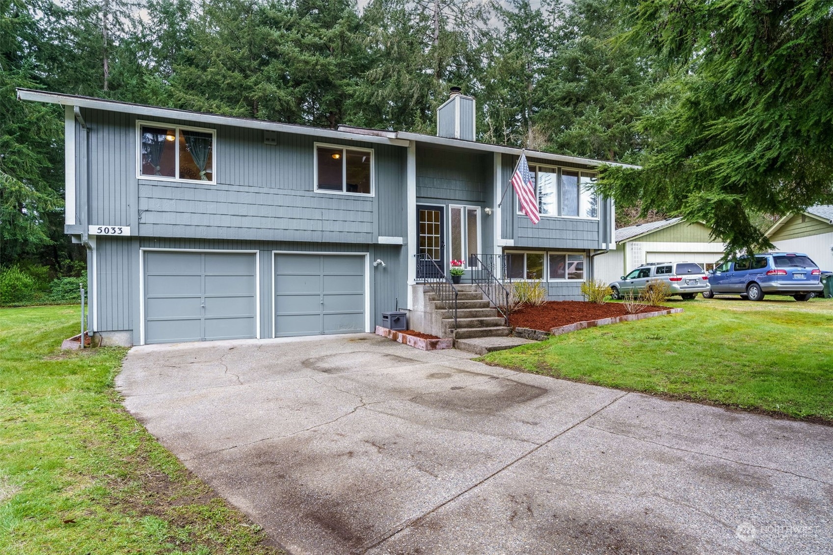 5033 Tri Lake Loop Southeast Olympia, WA 98513 - Photo 2 of 34 a front view of a house with a yard and garage