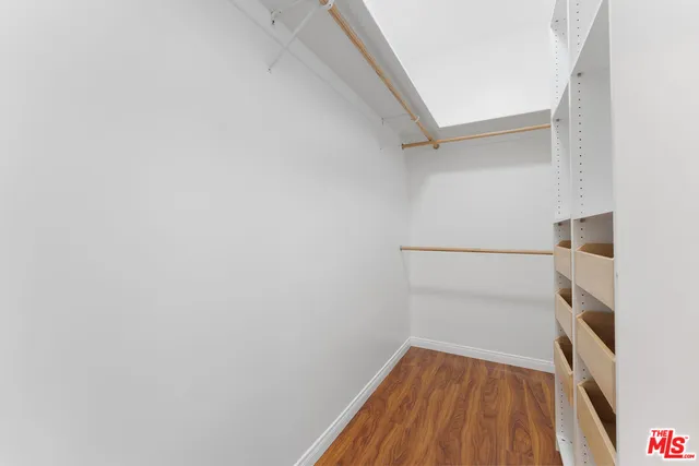 a bathroom with a granite countertop sink a toilet a mirror and shower