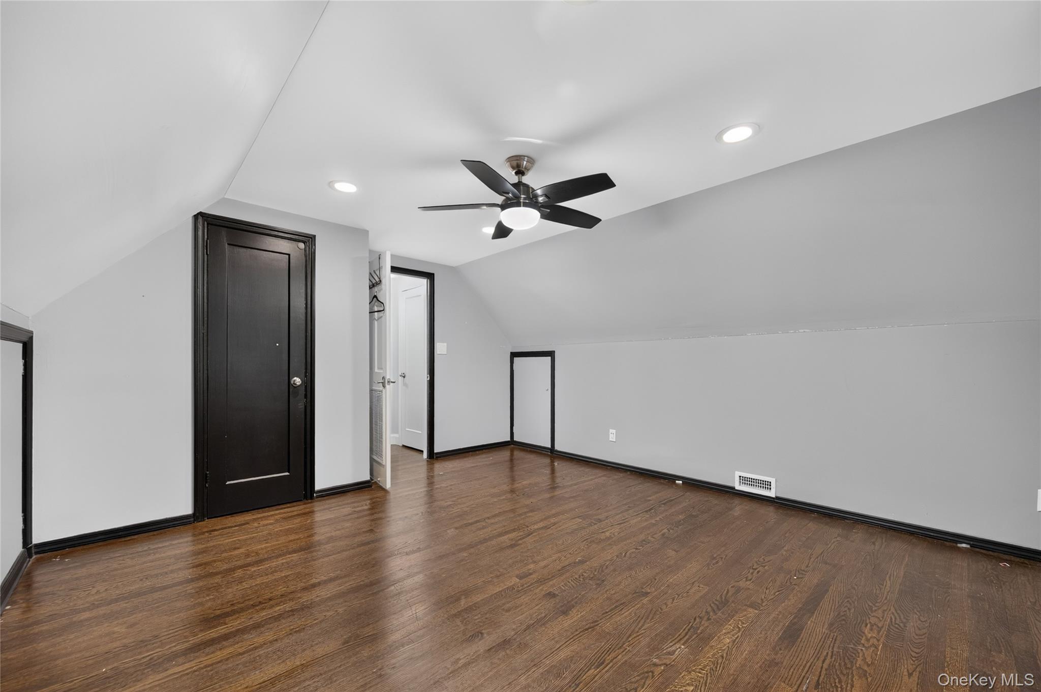 175 Wardwell Road Mineola, NY 11501 - Photo 18 of 25 an empty room with wooden floor a ceiling fan and closet