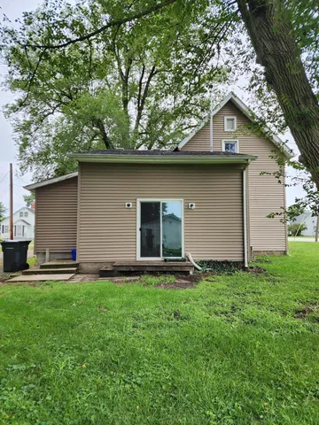 a front view of house with yard and trees