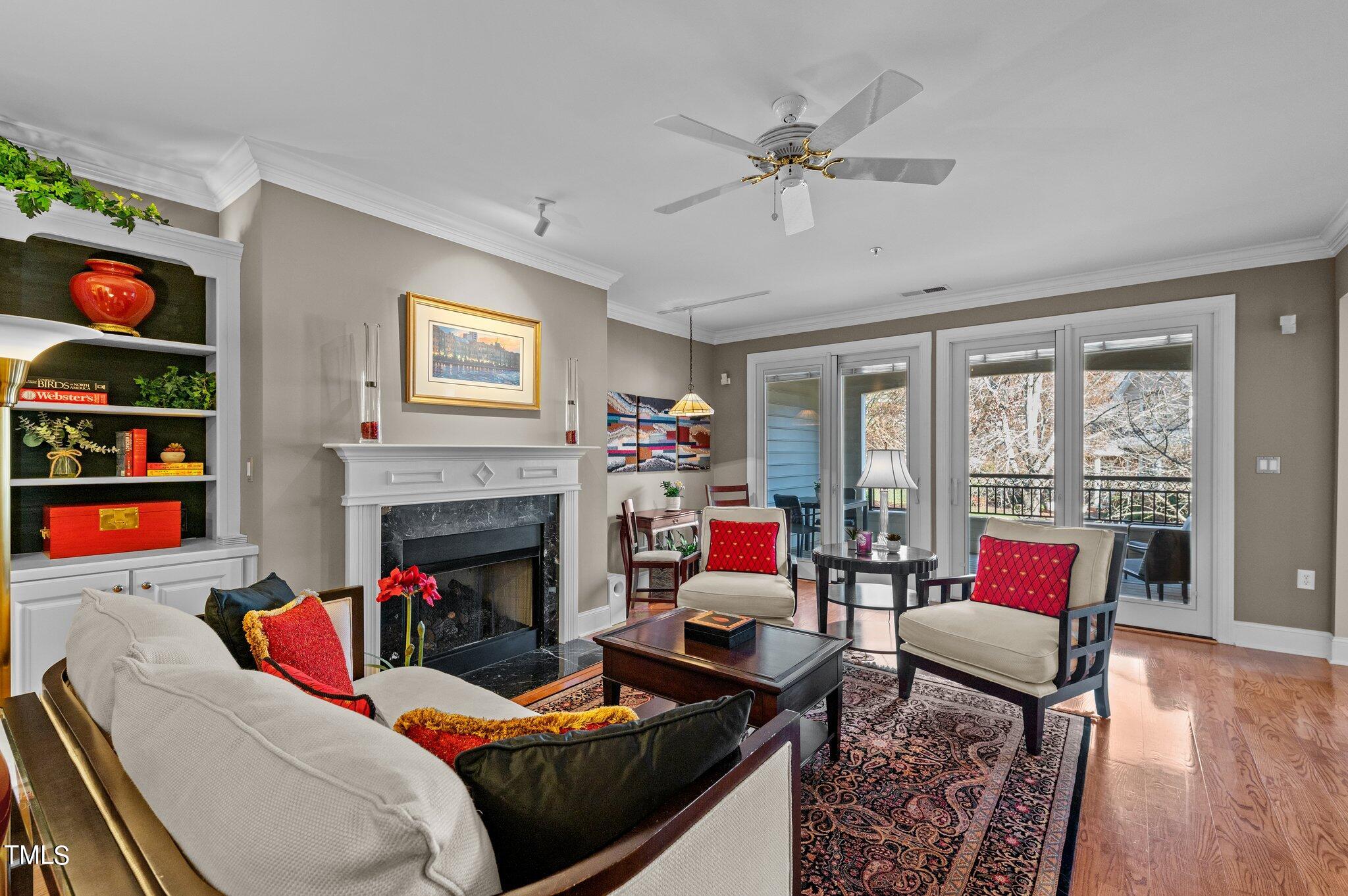 3700 Baron Cooper Pass, Unit 202 Raleigh, NC 27612 - Photo 15 of 49 a living room with furniture fireplace and flat screen tv