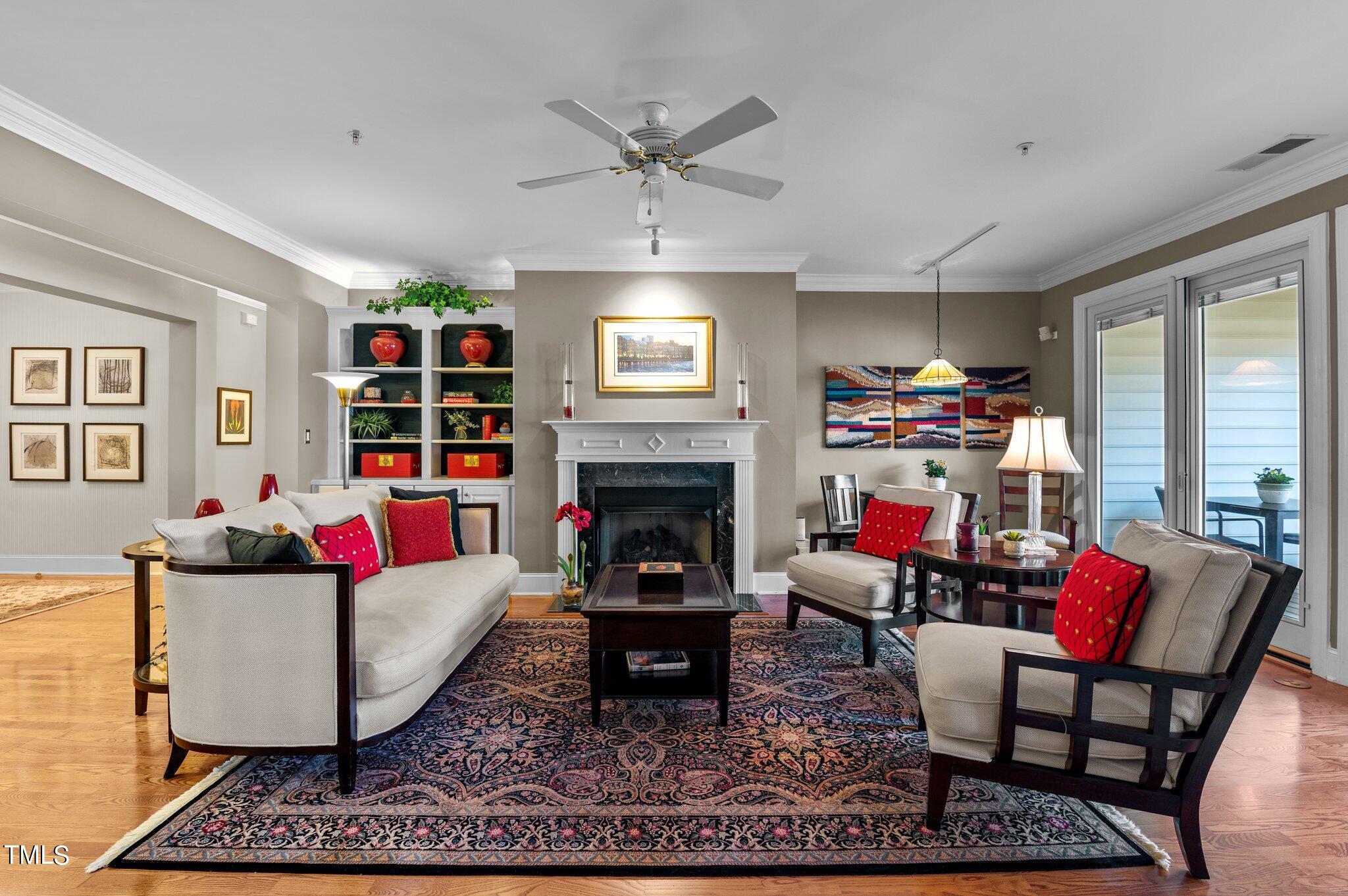 3700 Baron Cooper Pass, Unit 202 Raleigh, NC 27612 - Photo 16 of 49 a living room with furniture and a fireplace