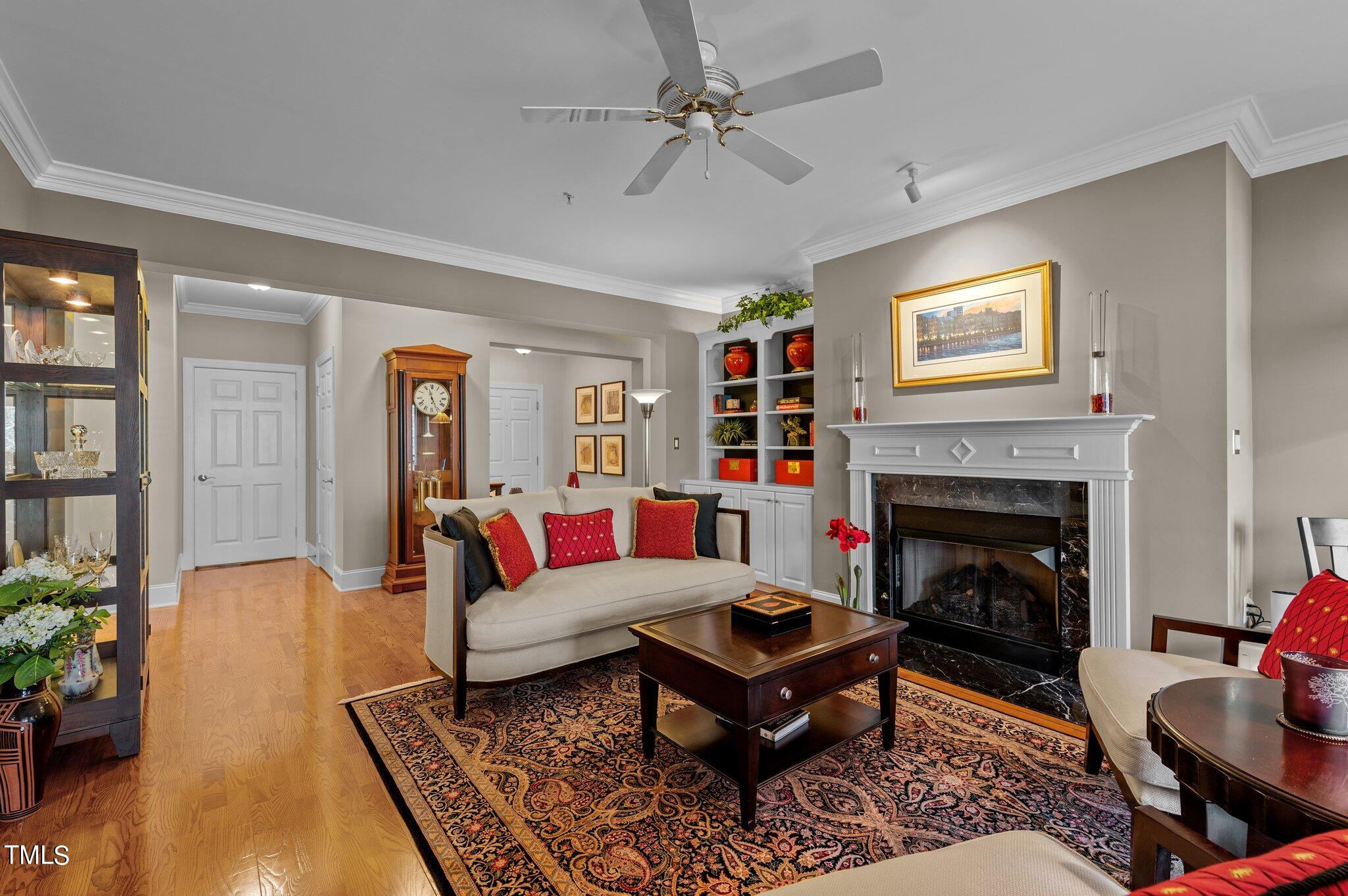 3700 Baron Cooper Pass, Unit 202 Raleigh, NC 27612 - Photo 17 of 49 a living room with furniture and a fireplace