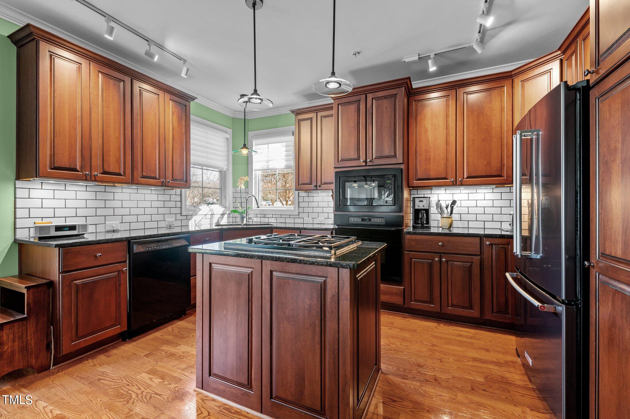 3700 Baron Cooper Pass, Unit 202 Raleigh, NC 27612 - Photo 22 of 49 a kitchen with granite countertop a refrigerator stove top oven and sink