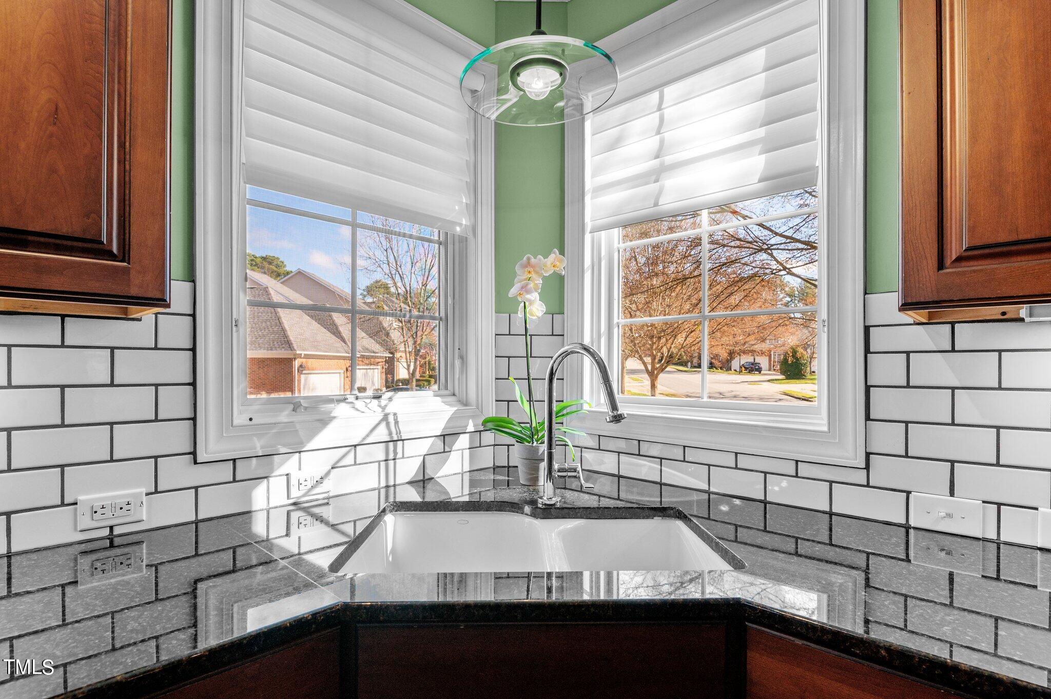 3700 Baron Cooper Pass, Unit 202 Raleigh, NC 27612 - Photo 24 of 49 a bathroom with a sink a mirror and next to a window