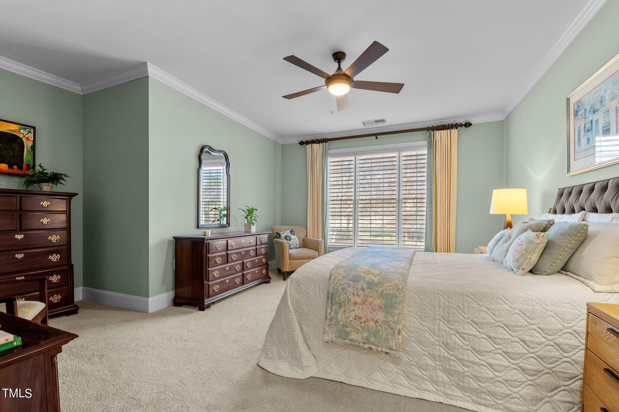 3700 Baron Cooper Pass, Unit 202 Raleigh, NC 27612 - Photo 28 of 49 a bedroom with a large bed and a window