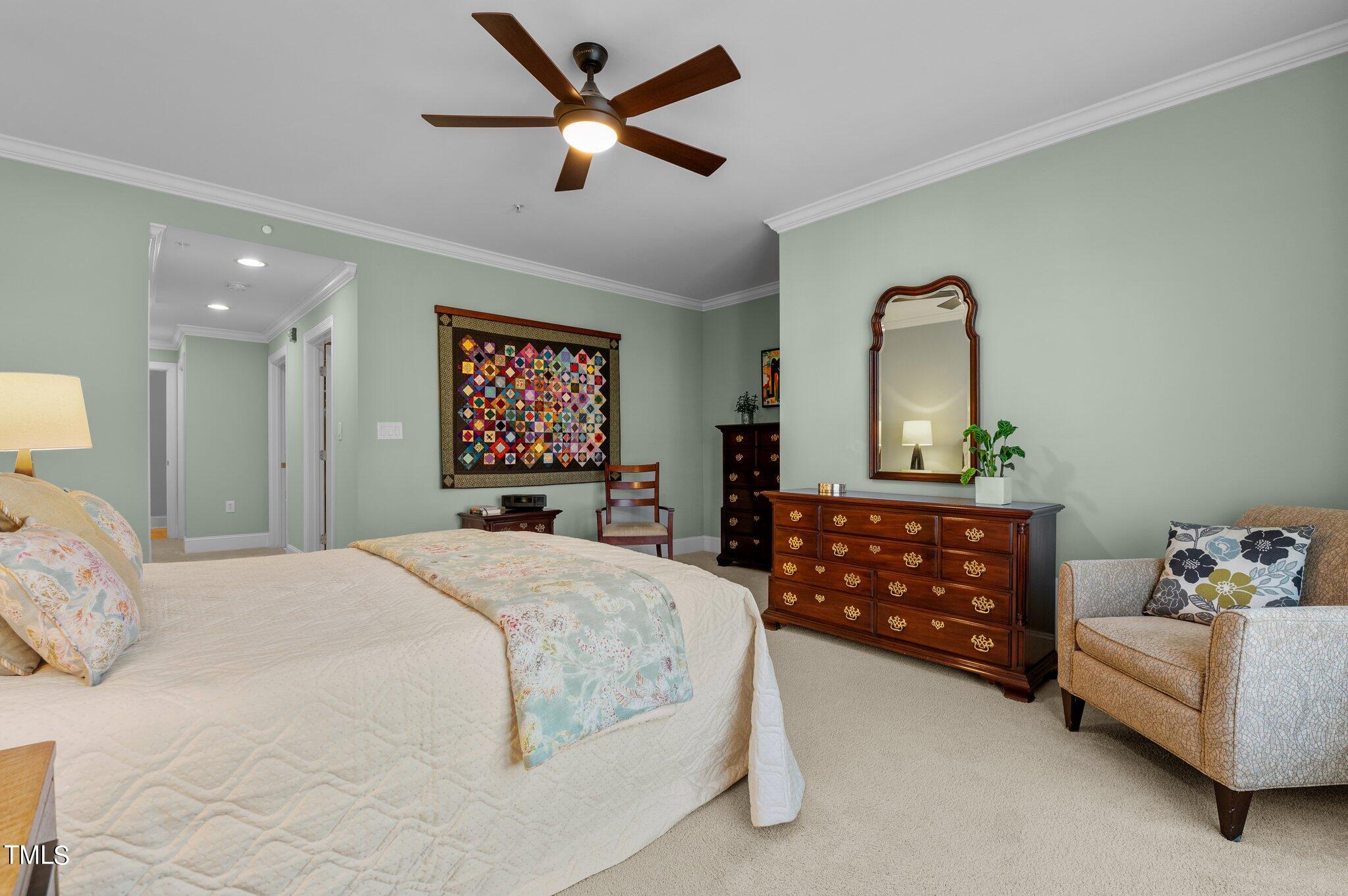3700 Baron Cooper Pass, Unit 202 Raleigh, NC 27612 - Photo 29 of 49 a bedroom with a bed chandelier and a window