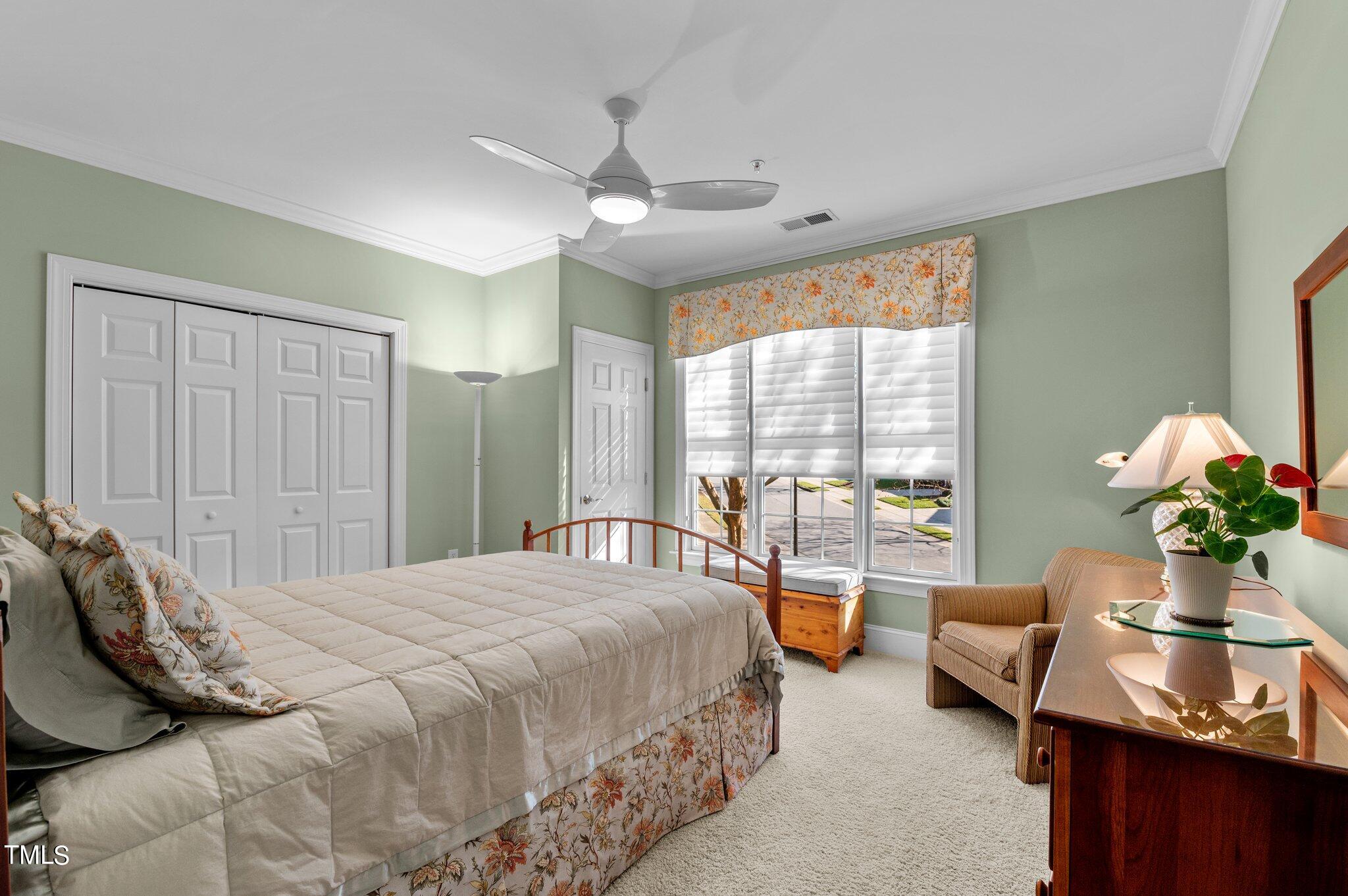 3700 Baron Cooper Pass, Unit 202 Raleigh, NC 27612 - Photo 35 of 49 a bedroom with a bed couch and large windows