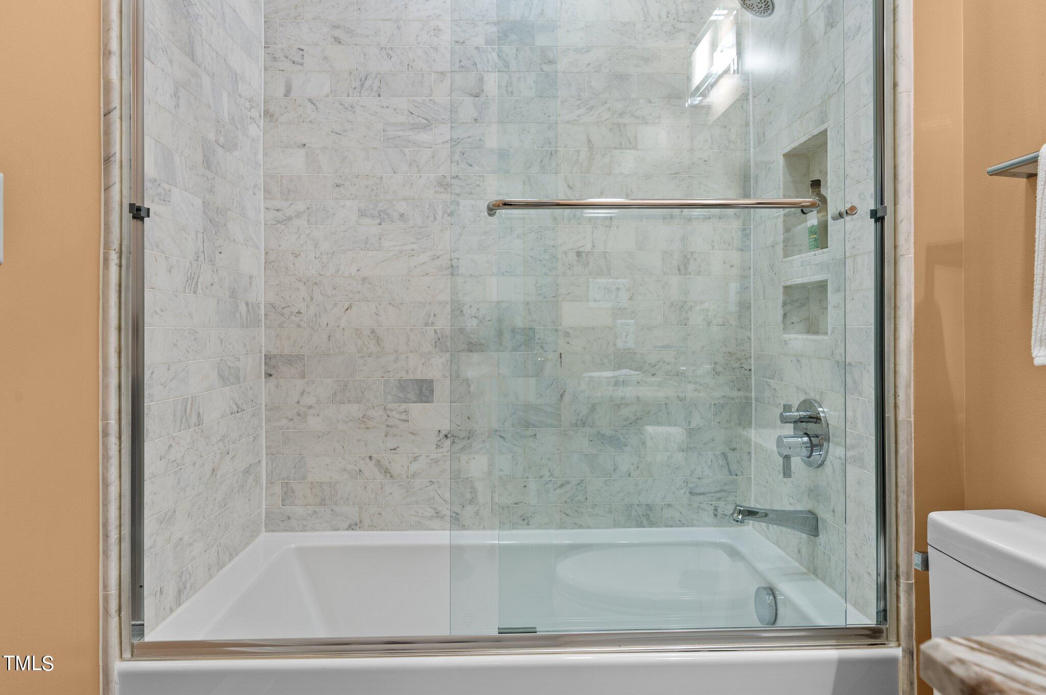 3700 Baron Cooper Pass, Unit 202 Raleigh, NC 27612 - Photo 37 of 49 a bathroom with a bathtub
