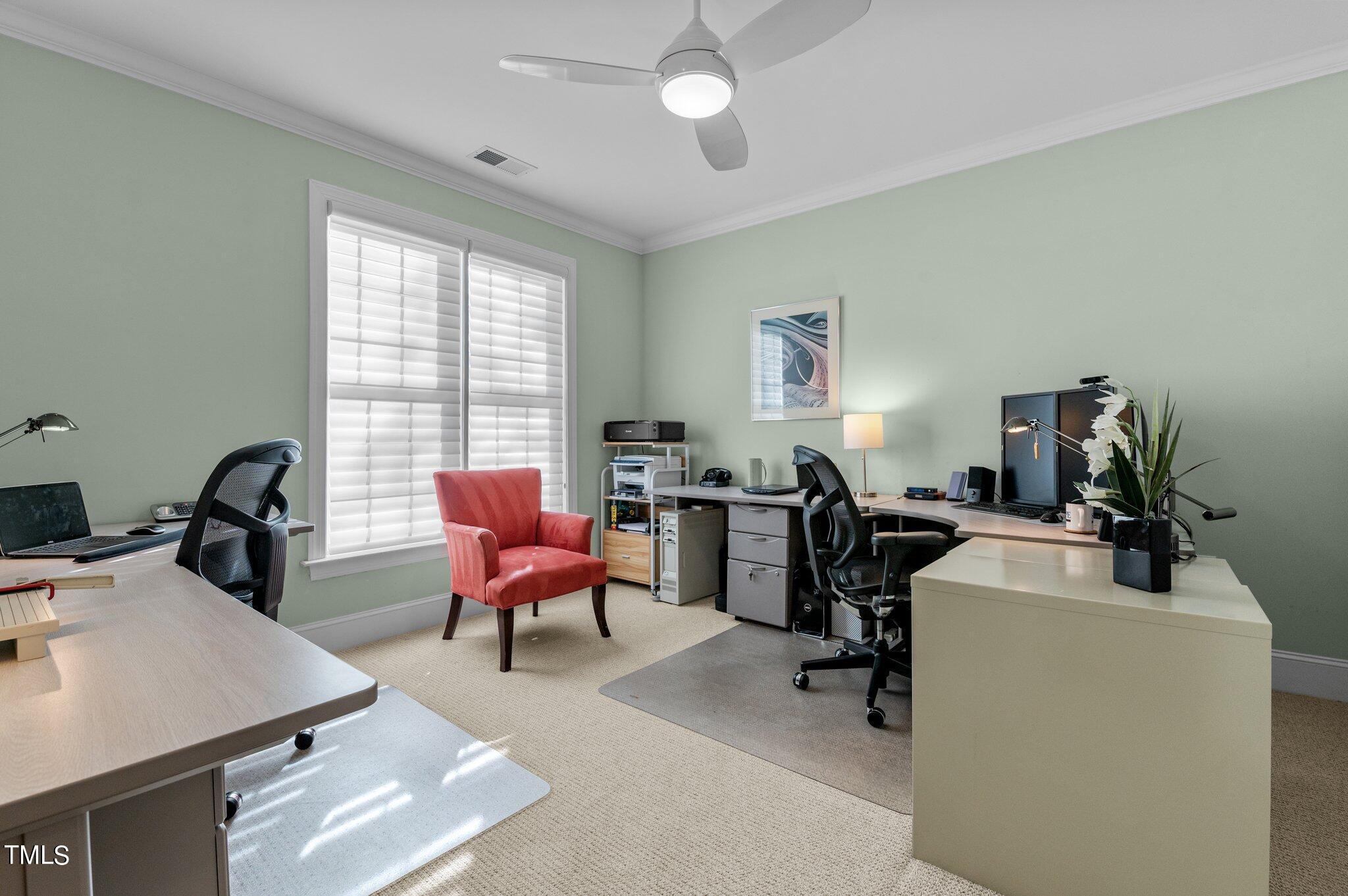 3700 Baron Cooper Pass, Unit 202 Raleigh, NC 27612 - Photo 38 of 49 a view of a workspace with furniture and a window