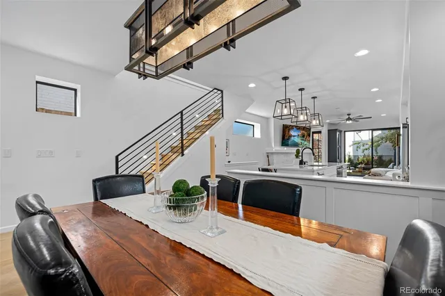 a view of a dining room with furniture and potted plant